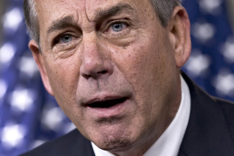 House Speaker John Boehner of Ohio reacts in animated fashion to criticism by conservative groups of a bipartisan budget bill, December 12, 2013, during a news conference on Capitol Hill in Washington.