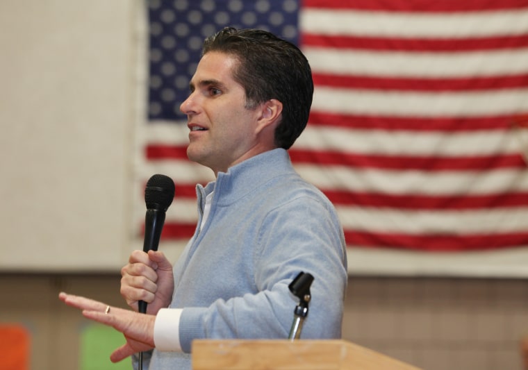 Tagg Romney speaks on behalf of his father, Republican presidential candidate Mitt Romney, during the Kennebec County Super Caucus in Augusta, Maine on Saturday, Feb. 4, 2012. (AP Photo/Joel Page)