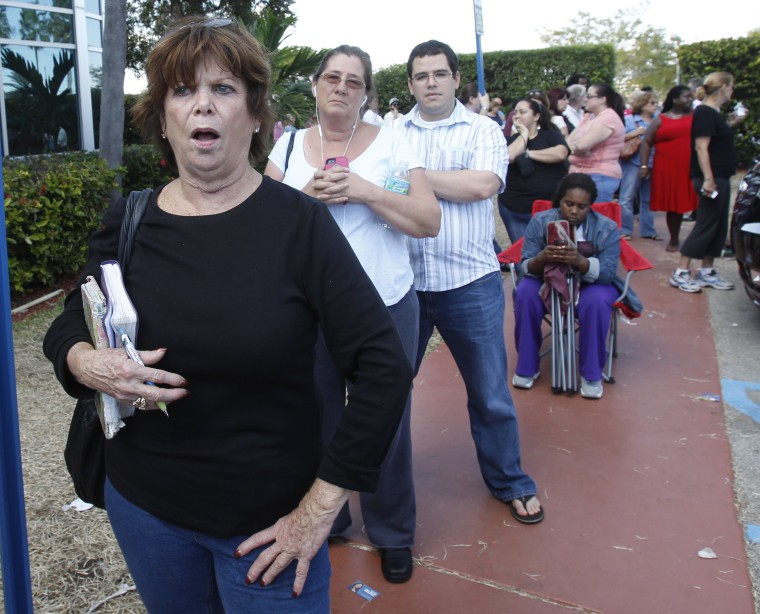 Elections office in Miami-Dade County closed its doors to voters who waited in long lines for an absentee ballot, Sunday. The doors were reopened  after  voters demanded to vote. (AP Photo/Alan Diaz)