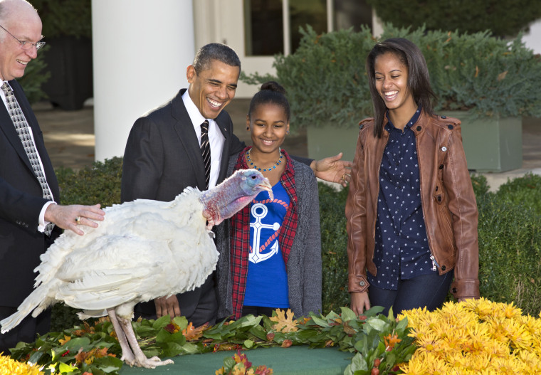 President Barack Obama, with daughters Sasha, center, and Malia, right, carries on the Thanksgiving tradition of saving a turkey from the dinner table with a \"presidential pardon,\" at the White House in Washington, Wednesday, Nov. 21, 2012.  After the...