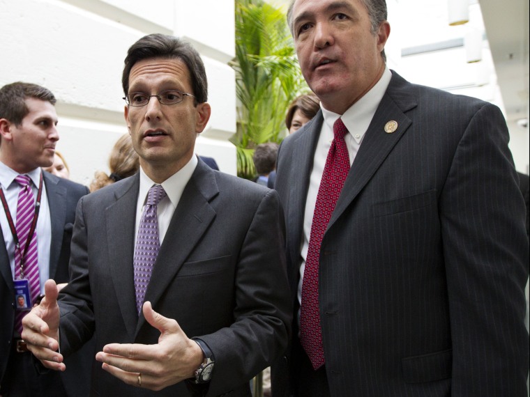 File Photo: House Majority Leader Eric Cantor, R-Va., left, confers with Rep. Trent Franks, R-Ariz., right, following a weekly House GOP strategy session, at the Capitol, Tuesday, May 8, 2012.  (Photo by J. Scott Applewhite/ AP Photo)