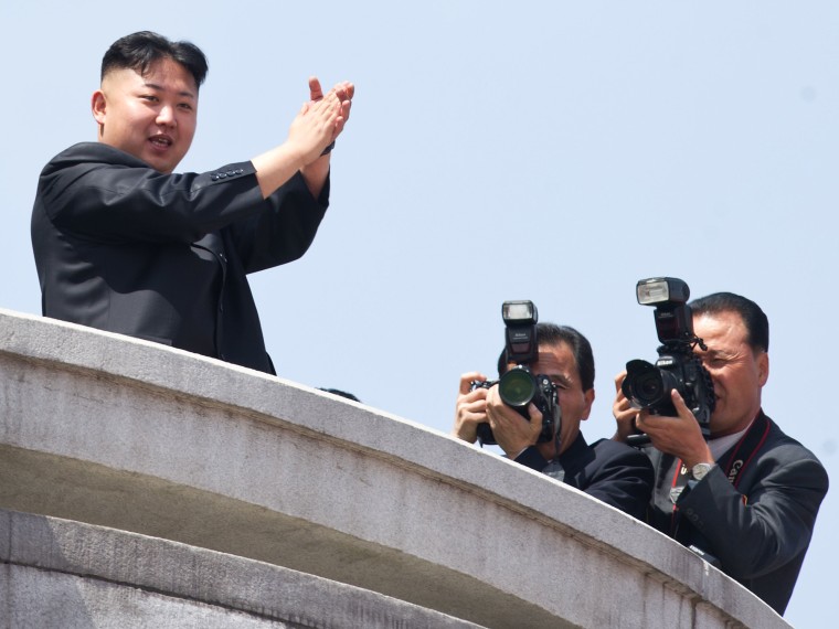File photo: North Korean leader Kim Jong-Un (L) applauds during a military parade in honour of the 100th birthday of the late North Korean leader Kim Il-Sung in Pyongyang on April 15, 2012.  (Photo by Ed Jones/AFP/Getty Images file)