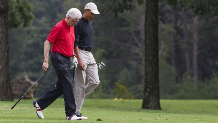 File Photo: President Barack Obama, right, talks with former President Bill Clinton while playing a game of golf at Andrews Air Force Base on Saturday, Sept. 24, 2011, in Andrews Air Force Base, Md. (AP Photo/Evan Vucci)