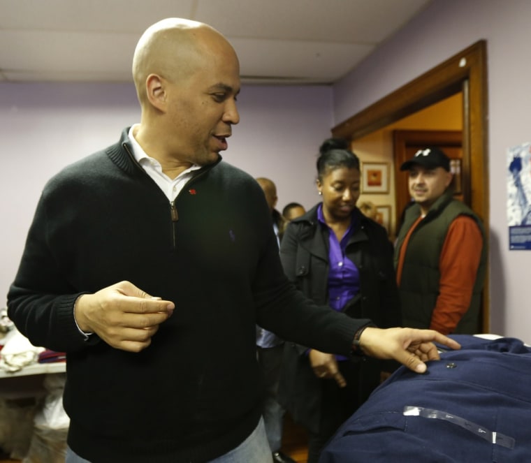 Newark Mayor Cory Booker looks over clothing donations for residents impacted by Superstorm Sandy, at Clinton Hill Community Resource Center, Friday, Nov. 9, 2012, in Newark, N.J. (AP Photo/Julio Cortez)