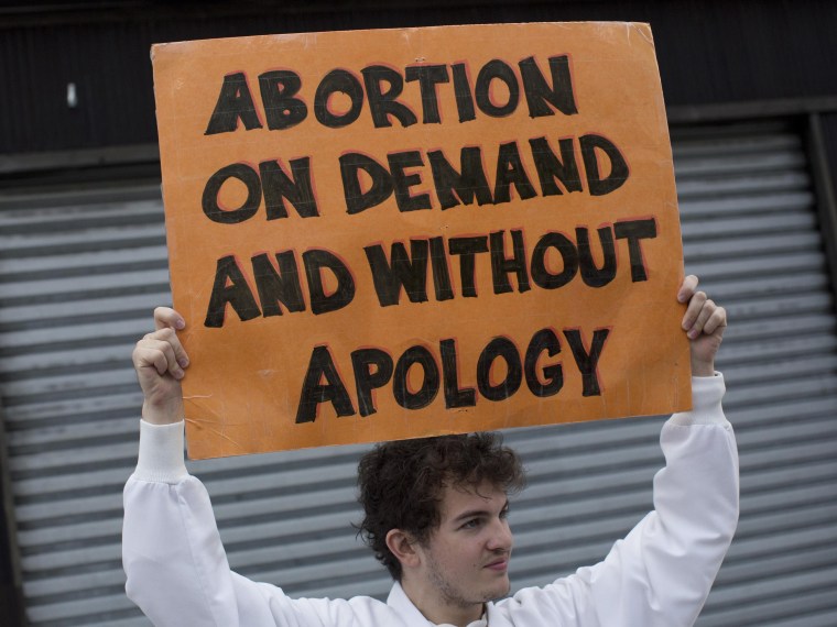 File Photo: A pro-abortion rights protester holds a sign as he confronts an anti-abortion demonstration organized by local church Presentation of the Blessed Virgin Mary in Queens, New York October 20, 2012. The protest was held outside the Choices...