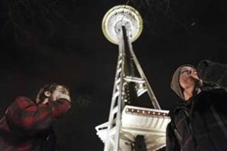 People light up near the Space Needle after the law legalizing the recreational use of marijuana went into effect in Seattle, Washington. (Photo: REUTERS/Cliff Despeaux)