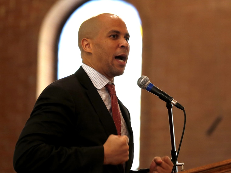 Newark Mayor Cory Booker talks to firefighter cadets during a swearing in ceremony into the Newark Fire Department. (Photo by Julio Cortez/AP)