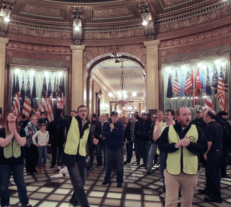 Union workers chant in the lower level of the Capitol rotunda in Lansing, Mich., Thursday, Dec. 6, 2012. (AP Photo/Carlos Osorio)
