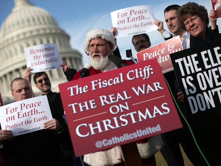 An unidentified man dressed as Santa Claus speaks outside the U.S. Capitol before making his way to Speaker of the House John Boehner's office on December 12, 2012 in Washington, DC.  (Photo by Win McNamee/Getty Images)