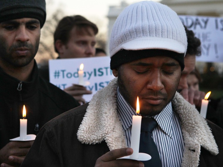Faisal Ali (R) of Colorado Springs, Colorado, joins other people outside the White House to participate in a candle light vigil to remember the victims at the Sandy Hook Elementary School shooting in Newtown, Connecticut on December 14, 2012 in...