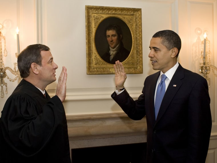This official White House photograph shows US President Barack Obama (R) retaking the oath of office from Chief Justice John Roberts (L)  January 21, 2009 in the Map Room of the White House in Washington, DC. (Photo by Pete Souza/AFP/Getty Images)
