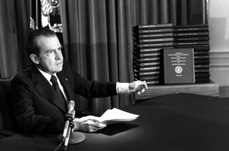 President Richard Nixon gestures toward transcripts of White House tapes after announcing he would turn them over to House impeachment investigators and make them public in April of 1974. (AP Photo)
