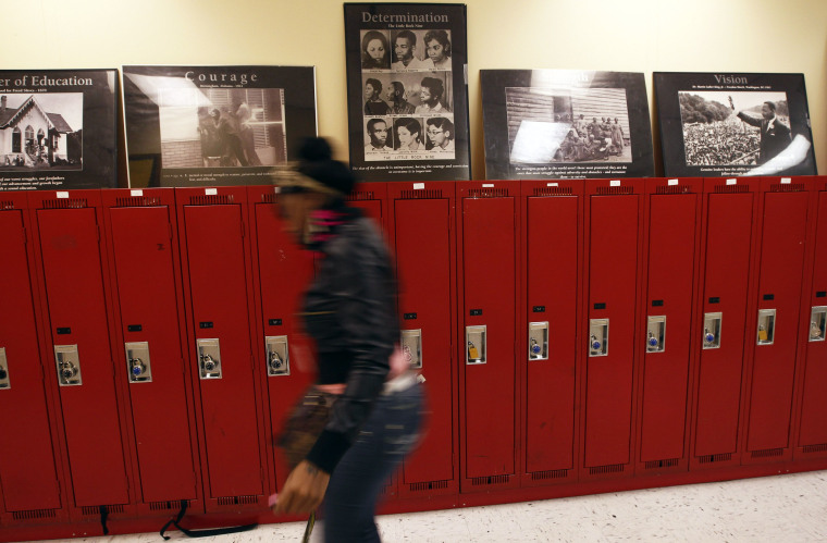 A student at Walter H. Dyett High School walks through the hallway in Chicago, Illinois, in this photo taken on October 5, 2012. The bipartisan education reform movement sweeping the nation calls for rating schools by their students' test scores and...