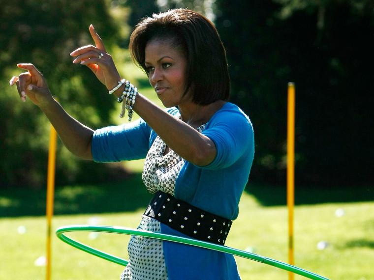 File Photo: U.S. first lady Michelle Obama hula hoops on the South Lawn of the White House during an event promoting exercise and healthy eating for children October 21, 2009.  (Photo by Win McNamee/Getty Images, File)