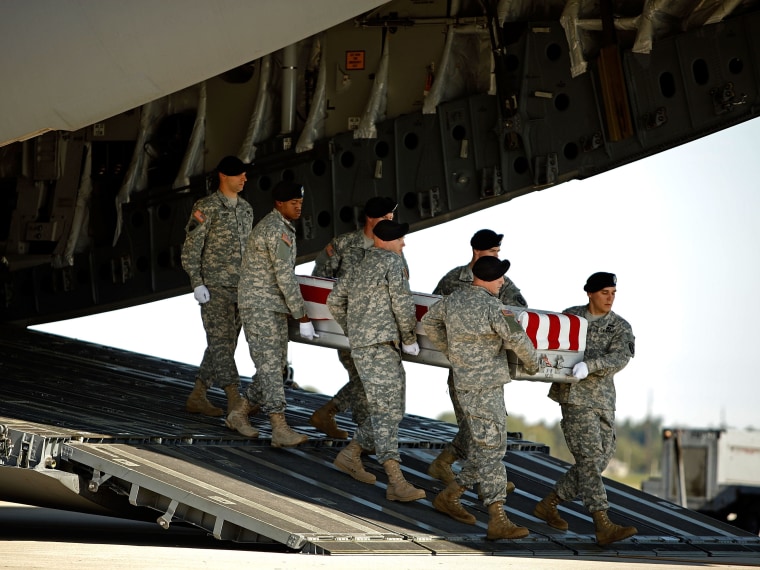 File Photo: U.S. Army soldiers carry the flag-draped transfer case containing the remains of U.S. Army Sergeant Vernon W. Martin of Savannah, Georgia, out of a C-17 during a dignified transfer on the tarmac at Dover Air Force Base October 6, 2009 in...