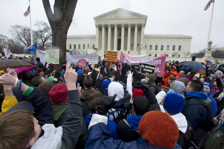 Anti-abortion and abortion rights supporters stand face to face in front of the Supreme Court in Washington, Monday, Jan. 23, 2012, during the annual March For Life rally.  (AP Photo/Manuel Balce Ceneta)