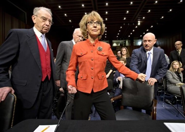 Former Arizona Rep. Gabrielle Giffords, who was seriously injured in the mass shooting that killed six people in Tucson, Ariz. two years ago, arrives on Capitol Hill in Washington, Wednesday, Jan. 30, 2013, for a hearing of the Senate Judiciary...