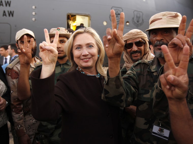 “V” is for victory as Hillary stands alongside Libyan fighters on October 18, 2011. (Photo by Kevin Lamarque/AFP/Getty Images)
