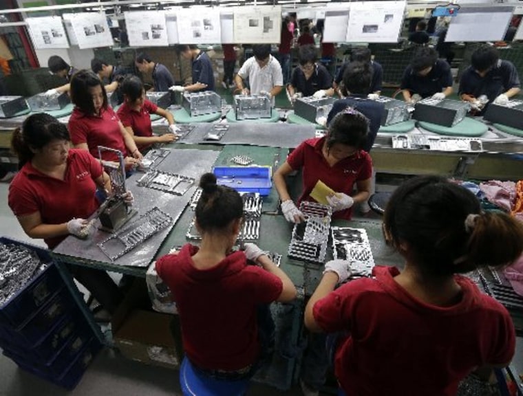 Employees work at a Foxconn factory in Wuhan, Hubei province, in this August 31, 2012 file photograph.  (REUTERS/Stringer/Files)