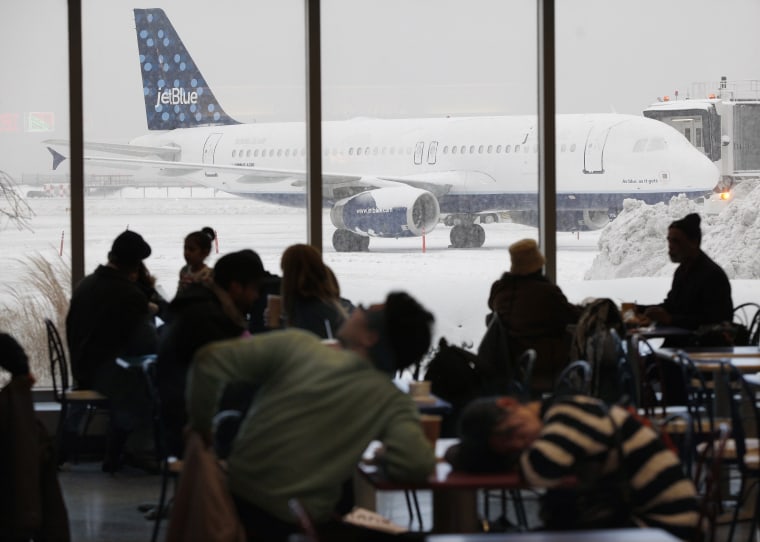 People wait in the food court as snow continues to accumulate during a 'Nor-Easter weather pattern bringing blizzard conditions to Laguardia airport, in New York, February 10, 2010. (Photo by Chip East/REUTERS)