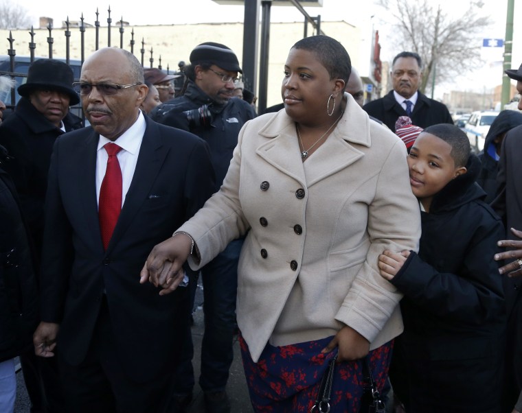Funeral Director Edward Calahan left, escorts Cleopatra Pendleton and her son Nathaniel Jr. inside the funeral home for the wake of Mrs. Pendleton's daughter Hadiya Friday, Feb. 8, 2013, in Chicago. A White House official says Pendleton will attend the...