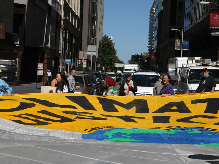 File Photo: Demonstrators block an intersection with a large banner as they protest the climate and energy bill that is currently before congress September 21, 2009 in San Francisco, California.(Photo by Justin Sullivan/Getty Images, File)