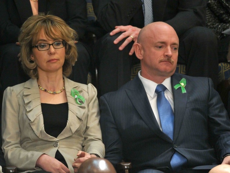 Former US Representative Gabrielle Giffords and her husband former astronaut Mark Kelly listen to US President Barack Obama deliver his State of the Union address before a joint session of Congress on February 12, 2013 at the US Capitol in Washington. ...