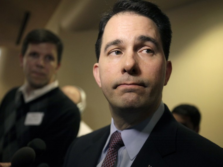 Wisconsin Gov. Scott Walker listens to a question while speaking with media about his proposed reforms to Medicaid, unemployment compensation, and food stamps, at Business Day in Madison. (AP Photo/Wisconsin State Journal, M.P. King)