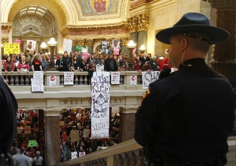 State Troopers maintain a perimeter around the assembly, as law enforcement officers block stairways in the Wisconsin State Assembly Chambers in Madison, Wisconsin March 10, 2011. (REUTERS/Allen Fredrickson)