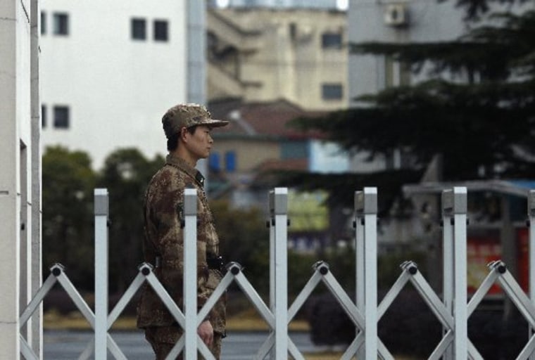 A Chinese People's Liberation Army soldier stands guard in front of 'Unit 61398', a secretive Chinese military unit, in the outskirts of Shanghai, February 19, 2013. The unit is believed to be behind a series of hacking attacks, a U.S. computer...