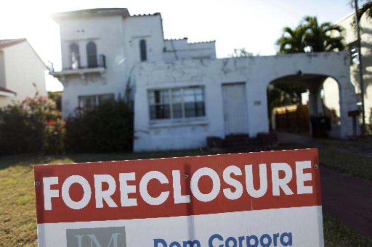 A foreclosure sale sign sits in front of a house in Miami Beach, Florida in 2009.  REUTERS/Carlos Barria/Files (UNITED STATES - Tags: BUSINESS REAL ESTATE)