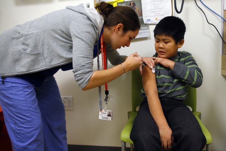 Nga Ngyen, 7, gets an influenza vaccine at a Boston clinic. Under sequestration, 212,000 low-income children and adults will lose needed vaccinations. REUTERS/Brian Snyder/Files