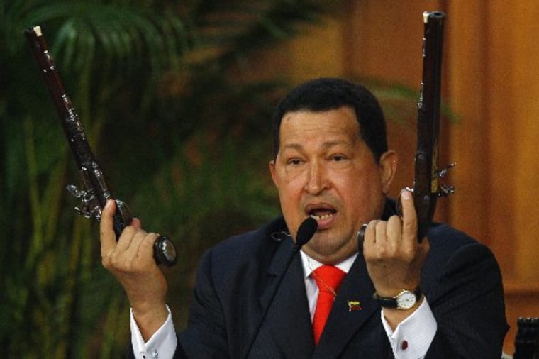 Venezuela's President Hugo Chavez shows the pistols of independence hero Simon Bolivar during a ceremony to mark the his birthday in Caracas in this July 24, 2012 file photo.  Chavez has died after a two-year battle with cancer, ending the socialist...