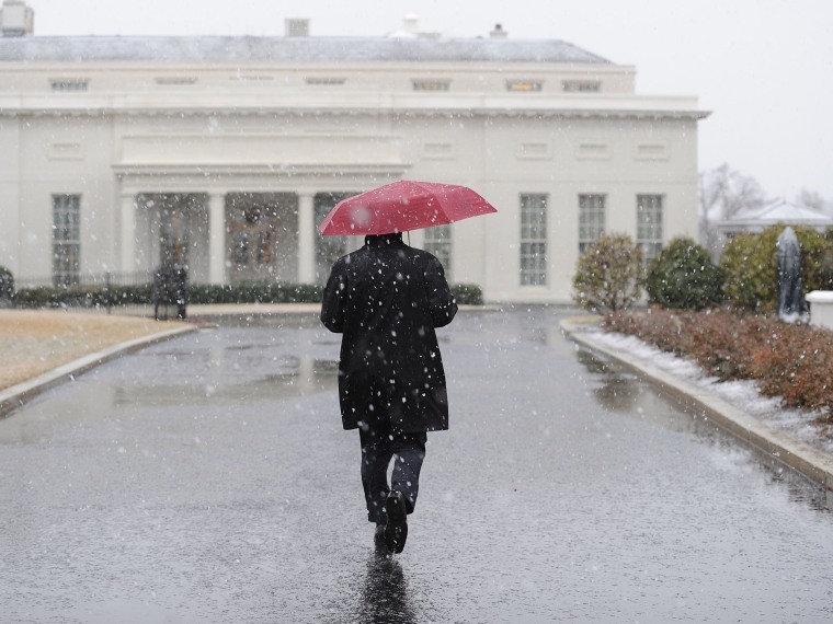 A White House staffer walks to the West Wing during a snow storm at the White House March 6, 2013 in Washington, DC. The snow forced all major school systems in the area to close, including today's White House press briefing.  (Photo by Olivier...