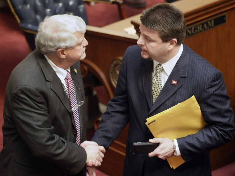 Sen. Jason Rapert, R-Conway, right, greets Sen. Bobby J. Pierce, D-Sheridan, on the floor of  the senate chamber at the Arkansas state Capitol in Little Rock, Ark., Tuesday, March 5, 2013. Pierce voted against an override of Gov. Mike Beebe's veto of...