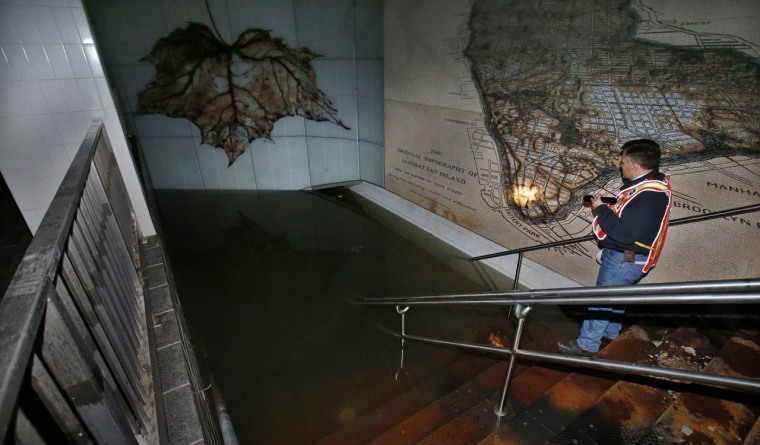 Image: Joseph Leader, vice president and chief maintenance officer of New York City Transit and MTA, stands in a flooded stairwell which leads down to a platform beneath street level at the flooded South Ferry-Whitehall Subway Terminal in lower Manhattan