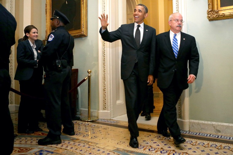 United States President Barack Obama is accompanied by Sergeant at Arms of the U.S. Senate Terrance Gainer...