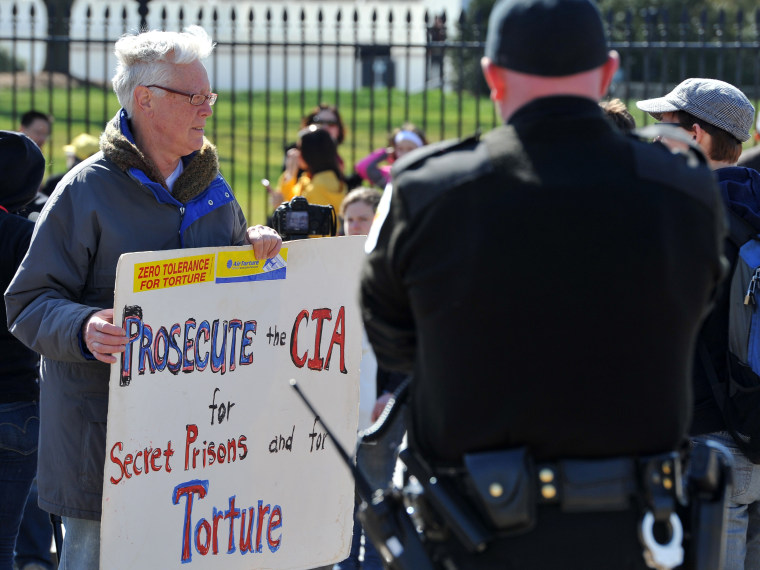 A man holds a poster accusing CIA of torturing Iraqi war prisoners as he protests outside the White House in Washington DC on March 19, 2013, the 10th anniversary of the beginning of the Iraq war. (Photo by Mladen Antonov/AFP/Getty Images)