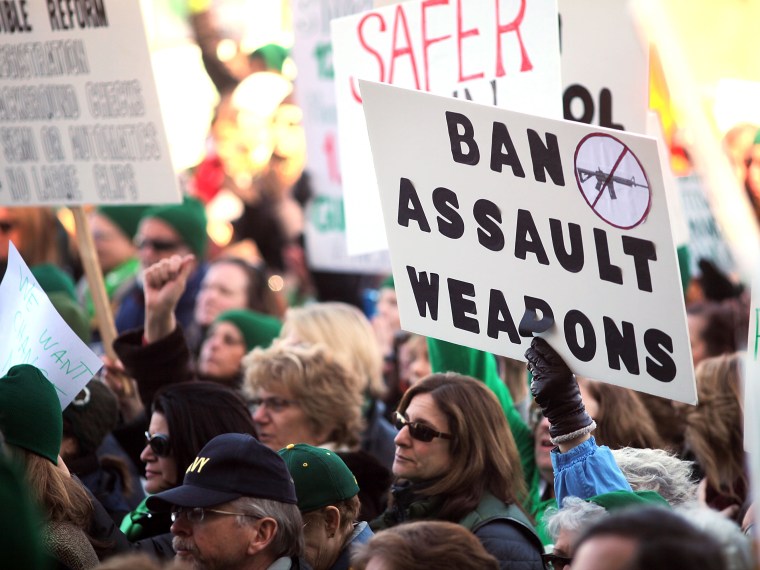 People hold signs during a rally at the Connecticut State Capital to promote gun control legislation in the wake of the December 14, 2012, school shooting in Newtown on February 14, 2013 in Hartford, Connecticut. Referred to as the \"March for Change\"...