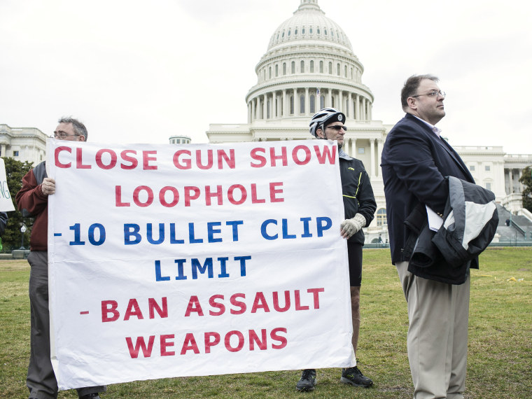 File Photo: Supporters with a group of 26 cyclists who rode from Newtown, Connecticut in support of common-sense solutions to gun violence hold up banners during a press conference with congress members from Connecticut on March 12, 2013 in Washington,...