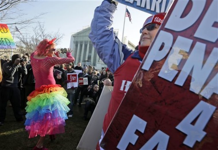 Qween Amar from Orlando, Fla., left, dances by Margie Phelps, right, a member of the Westboro Baptist Church, outside the Supreme Court. (AP Photo/Pablo Martinez Monsivais)