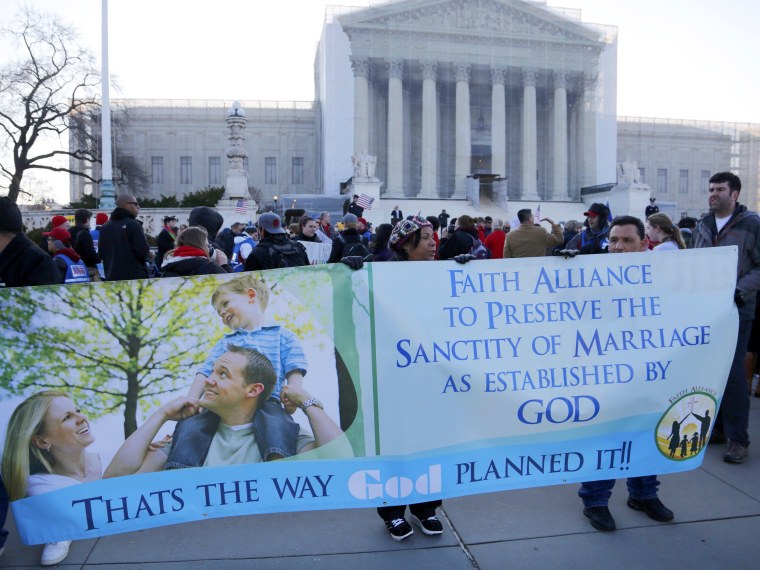Protesters in favor of Proposition 8 hold a banner outside of the U.S. Supreme Court in Washington, March 26, 2013. (Photo by Jonathan Ernst/Reuters)