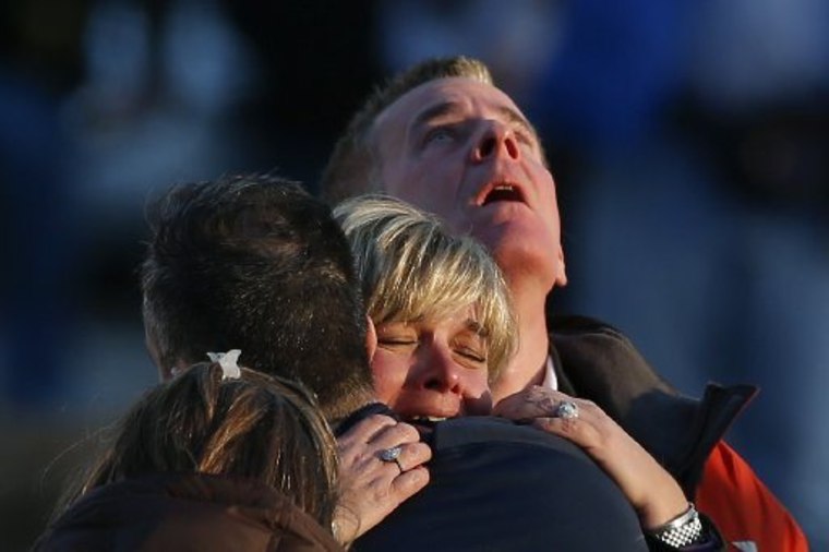 The families of victims grieve near Sandy Hook Elementary School, where a gunman opened fire on school children and staff in Newtown, Connecticut on December 14, 2012.(Photo by Adrees Latif/Reuters, File)