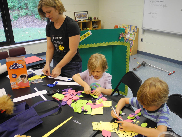 File Photo:  Parent volunteer Trinity Laurino, left, works on bulletin board decorations at Toomer Elementary School in Atlanta with her daughter, Olivia Laurino, center, and friend, Jake Jonsson in Atlanta. Atlanta Public Schools returns to classes...