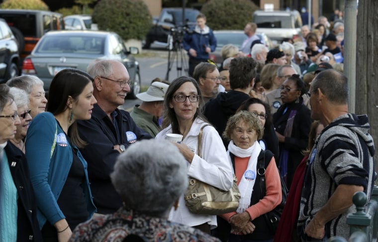 Voters stand in line before casting their ballots on the first day of early voting for the November election, Thursday, September 27, 2012, at the Polk County Election Office in Des Moines, Iowa. Iowa is one of 32 states that allow early voting.