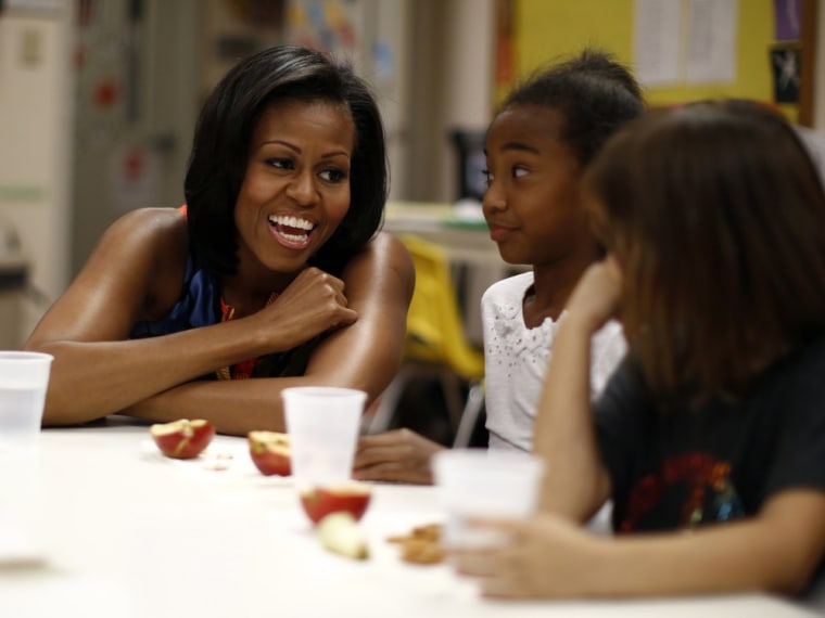 First lady Michelle Obama visits with young children in after-school care at the Rappahannock Area YMCA in Spotsylvania, Va., on Sept. 13, 2012.