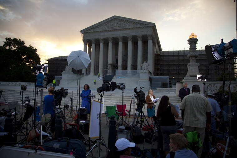 Journalists wait outside the Supreme Court for a landmark decision on health care on Thursday, June 28 in Washington.