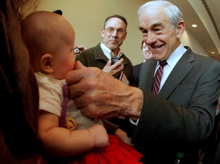 Republican presidential candidate, Rep. Ron Paul, R-Texas greets 3-month-old Heidi Lange during a campaign stop in Dubuque, Iowa, Thursday, Dec. 22, 2011.