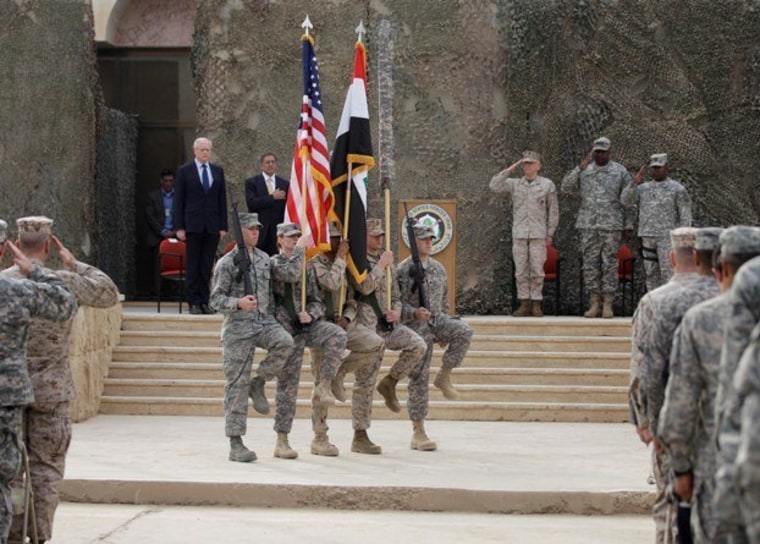The US flag, Iraq flag, and the US Forces Iraq colors are seen before they are carried in during ceremonies marking the end of US military mission in Baghdad, Iraq, Thursday, Dec. 15, 2011.