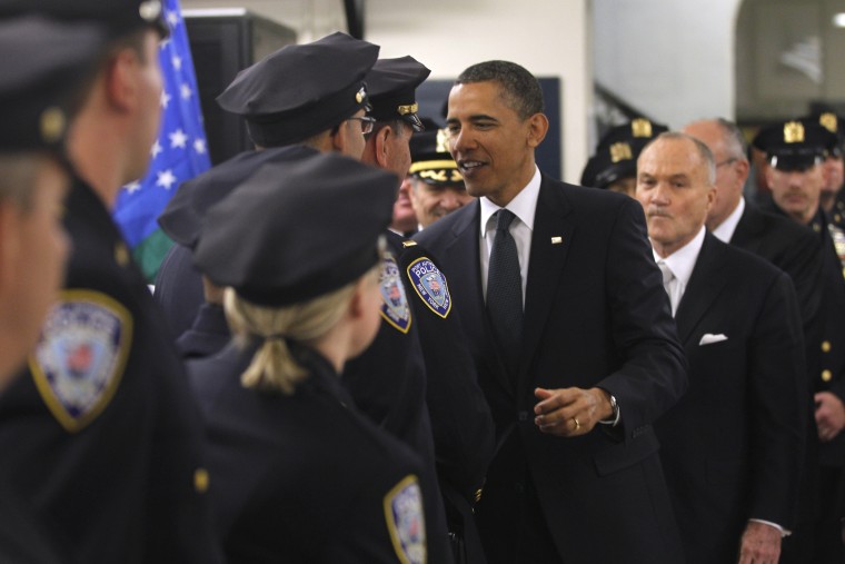 The president, accompanied by Police Commissioner Raymond Kelly, and others, meets with police officers and first responders at the First Precinct before visiting Ground Zero.
